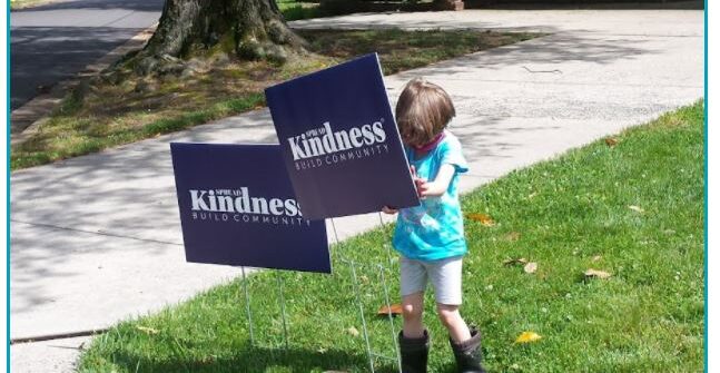 Child with Kindness signs.