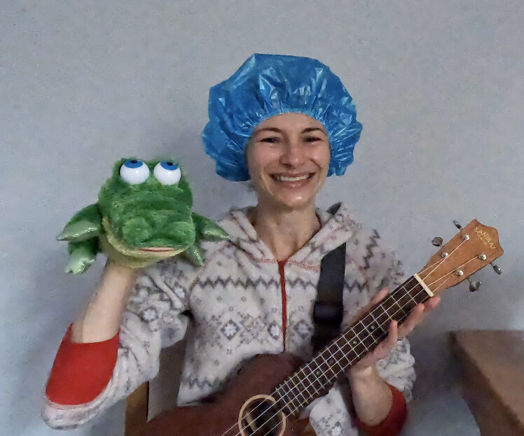Ms. Christina in shower cap with ukulele and alligator puppet