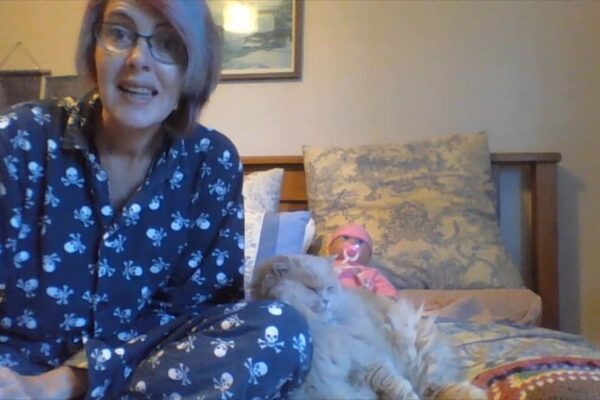 Anne doing online storytimes during lockdown in her skull pyjamas.