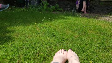 Feet on sunny grass.