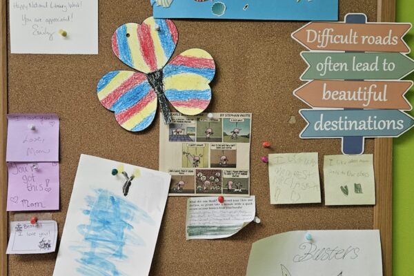 A collection of notes and love hearts, by children for a librarian.